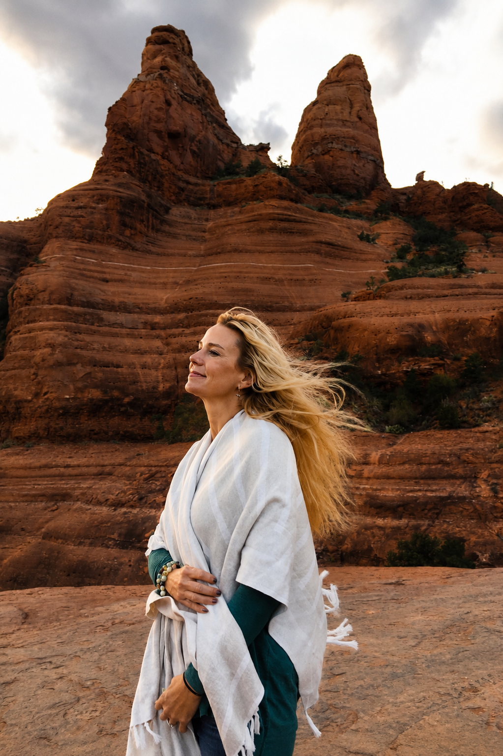 Kristy Bridgers smiling in the Sedona red rocks with wind in her hair
